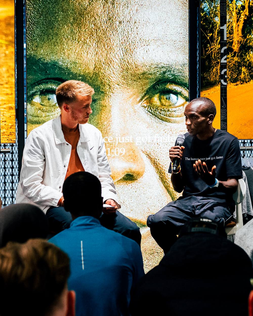 Lloyd on stage in conversation with Eliud Kipchoge at a Nike event in London