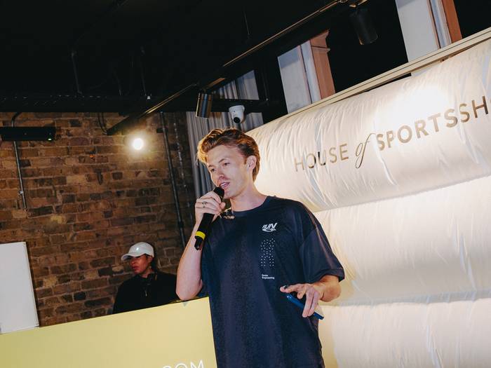 Lloyd presenting on stage at House of SportsShoes