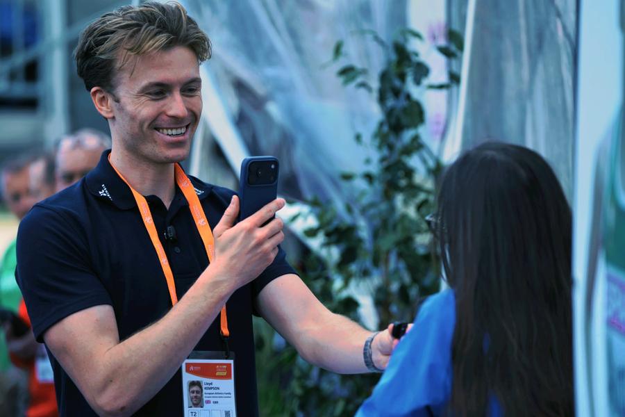 Lloyd filming an interview on his phone at the Birmingham 2026 European Athletics Championships