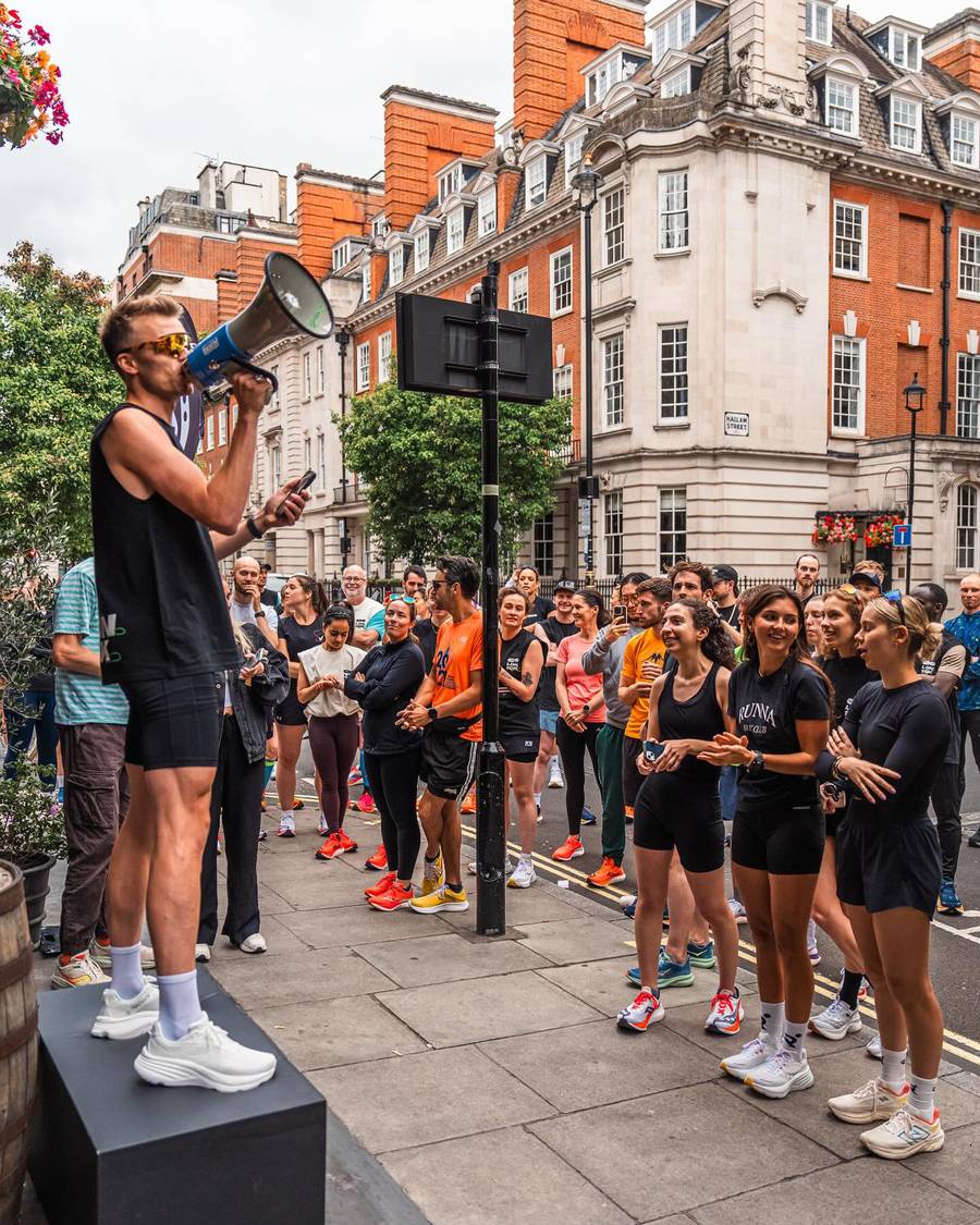 Lloyd addressing a crowd of runners through a megaphone