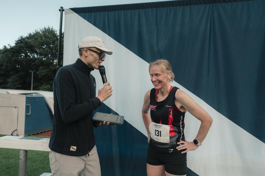 Lloyd interviewing a runner at the Tracksmith Twilight 5000