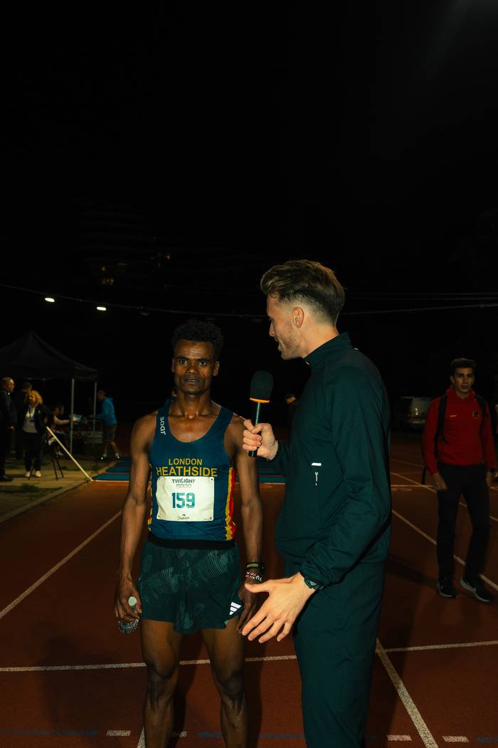 Lloyd interviewing the winner at the Tracksmith Twilight 5000